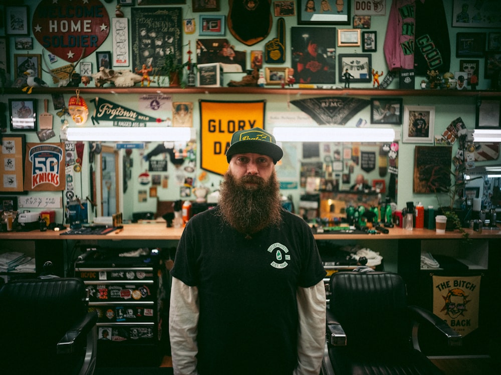 a man with a beard standing in a barber shop