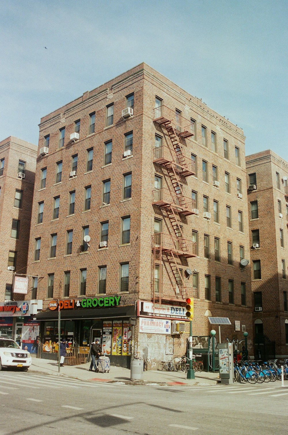 a tall brick building with a fire escape next to it