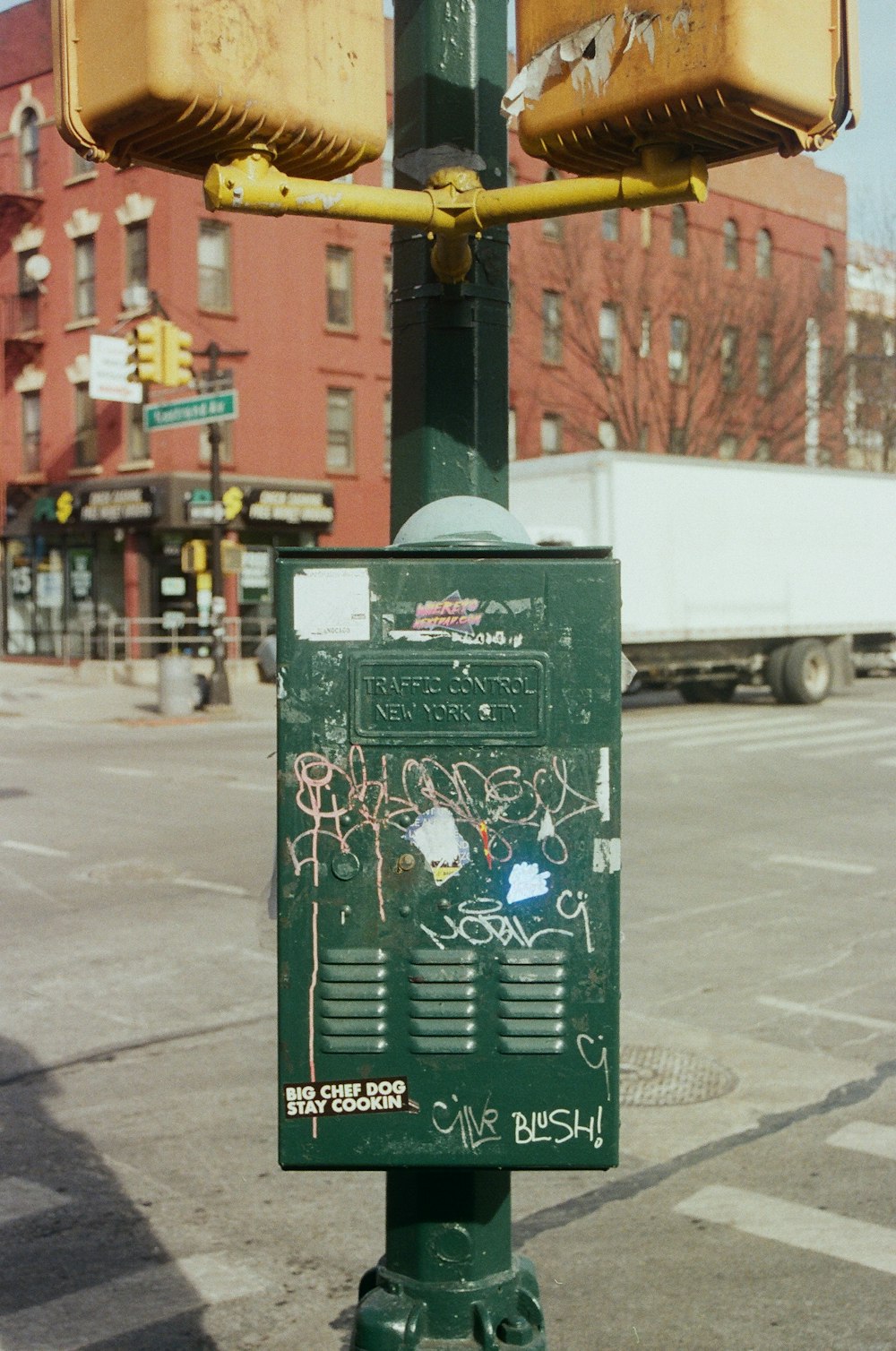 a green street light sitting on the side of a road