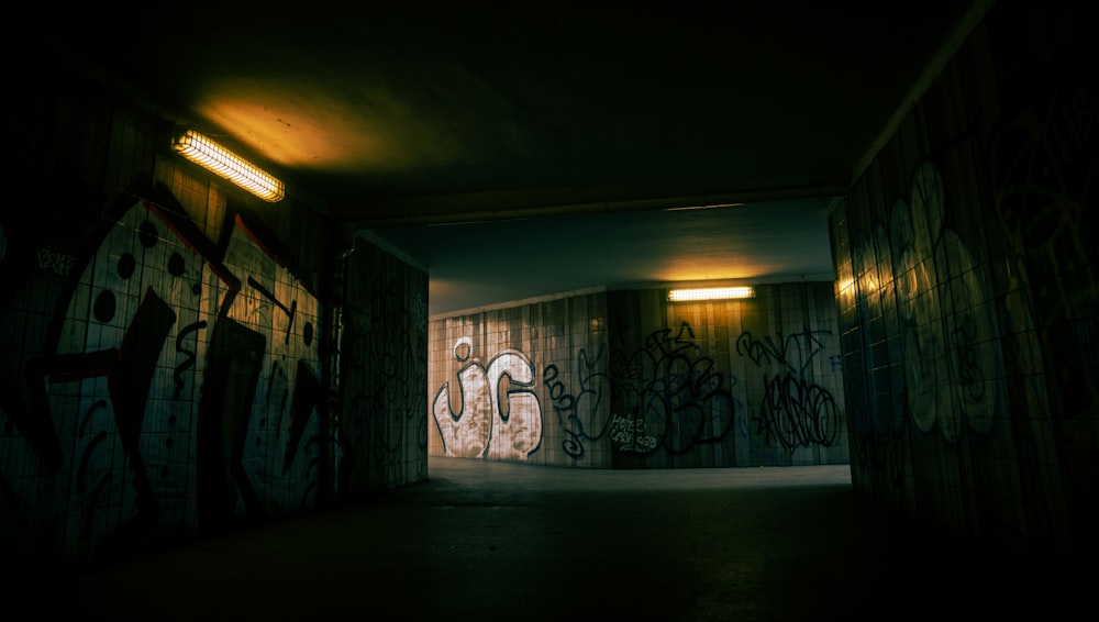 a dark room with graffiti on the walls