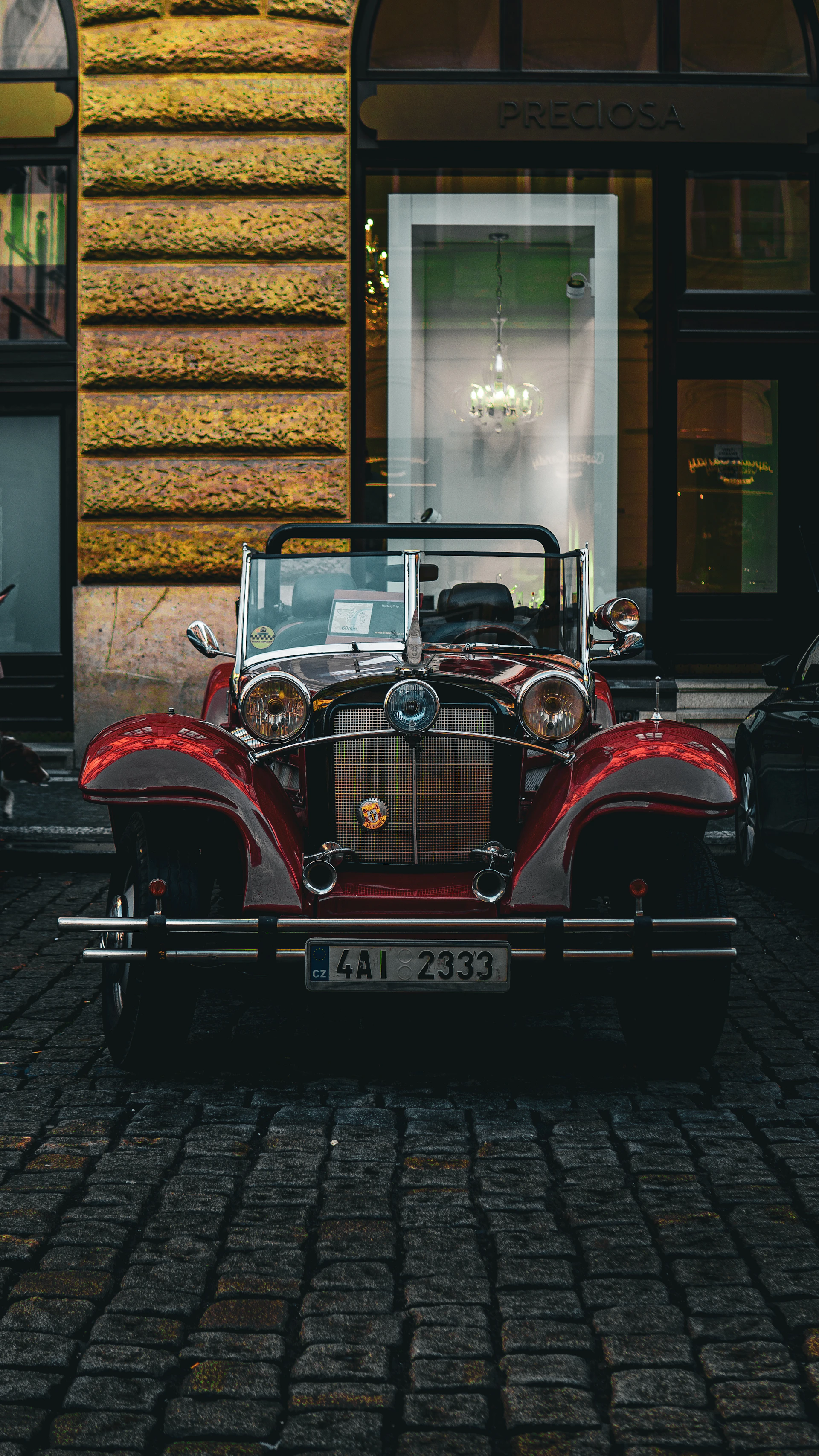 a red car parked in front of a building