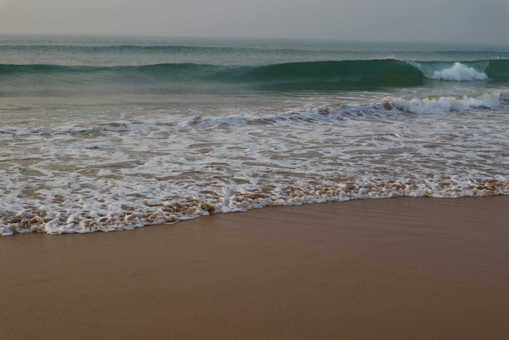 a beach with waves coming in to shore