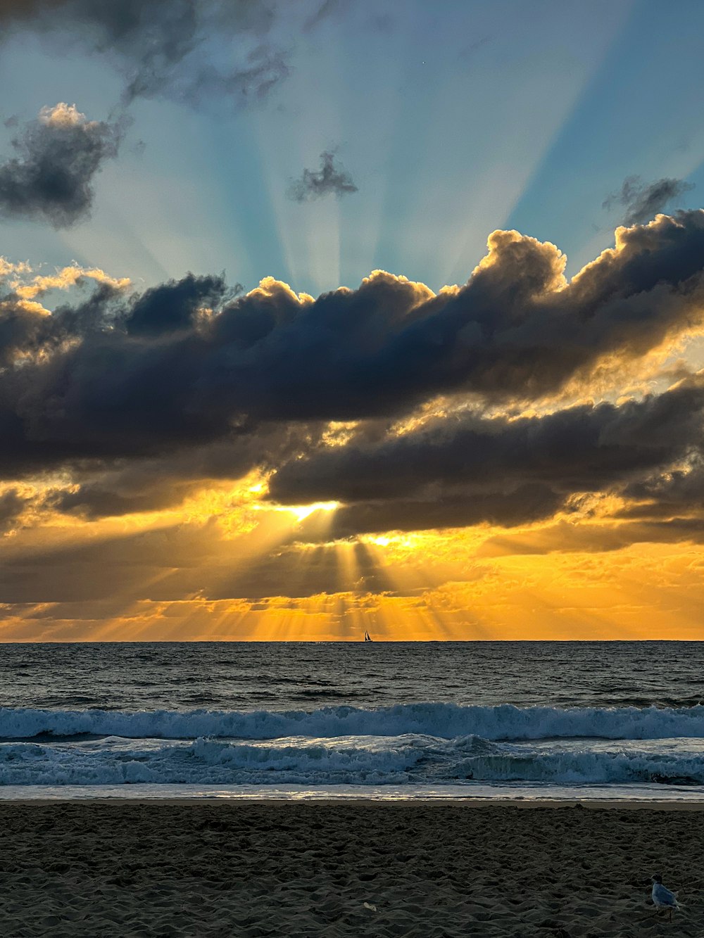 the sun is shining through the clouds over the ocean