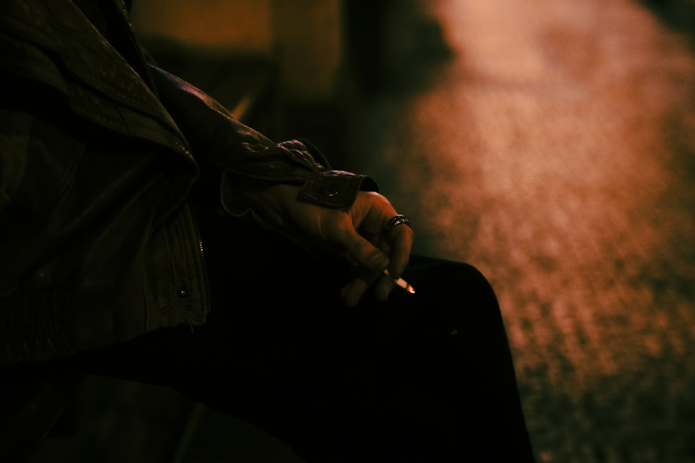 a person sitting on a bench holding a cell phone