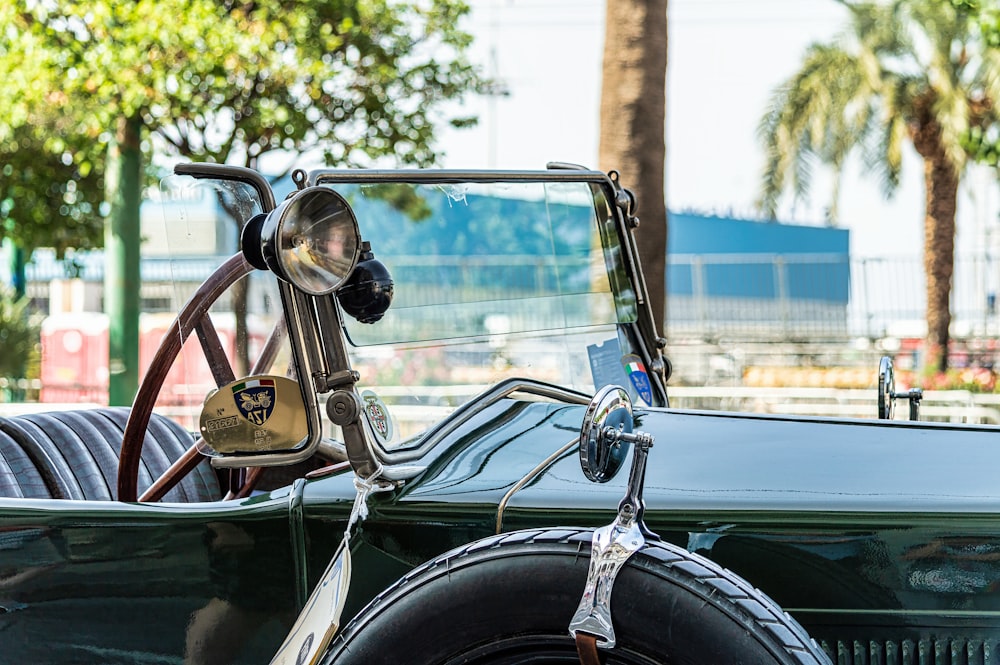 an old car with a steering wheel and a leather seat