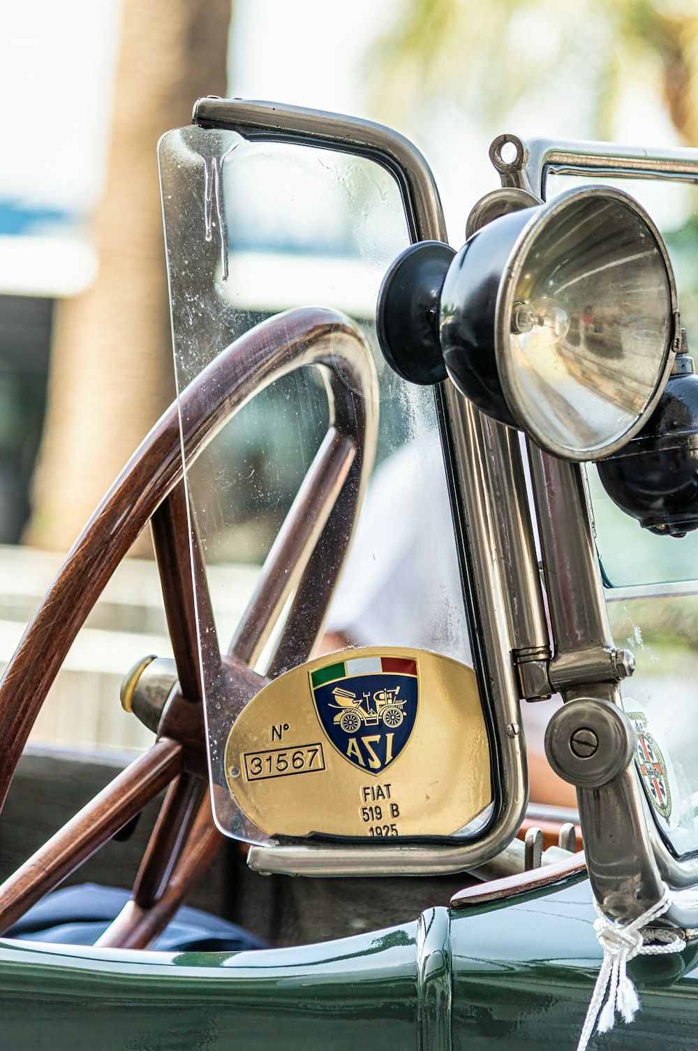 a close up of a car mirror with a steering wheel