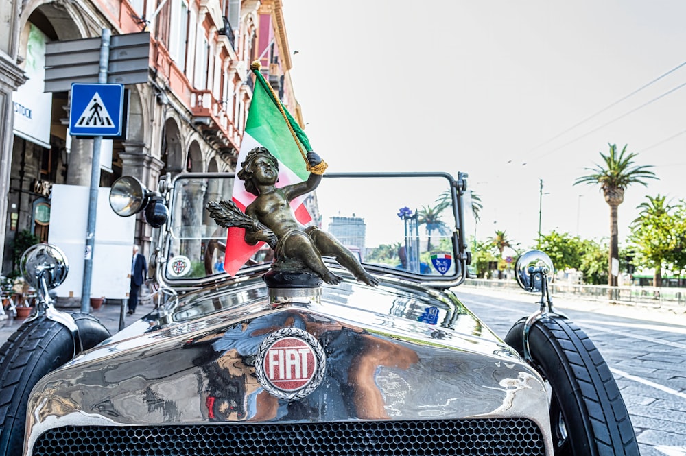 a statue of a man riding on the back of a car