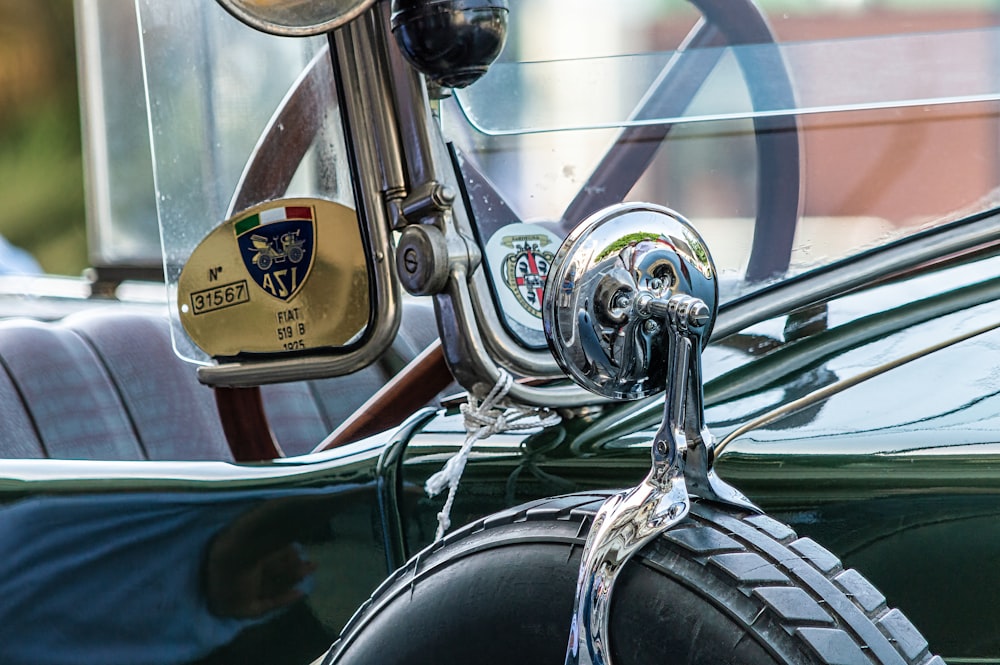 a close up of a car mirror with a steering wheel