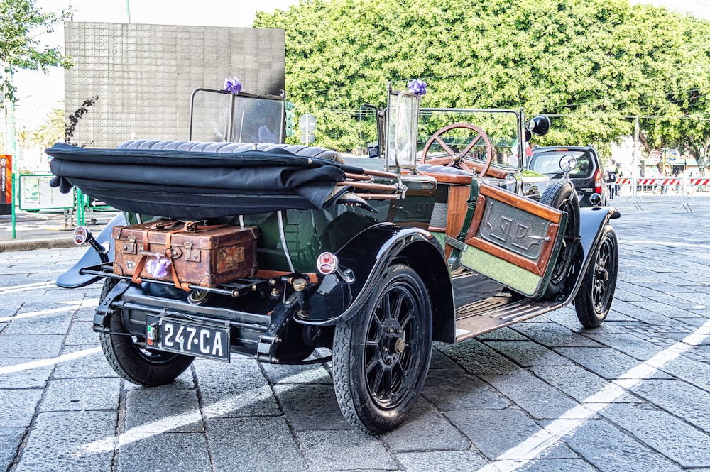 an old fashioned car is parked in a parking lot