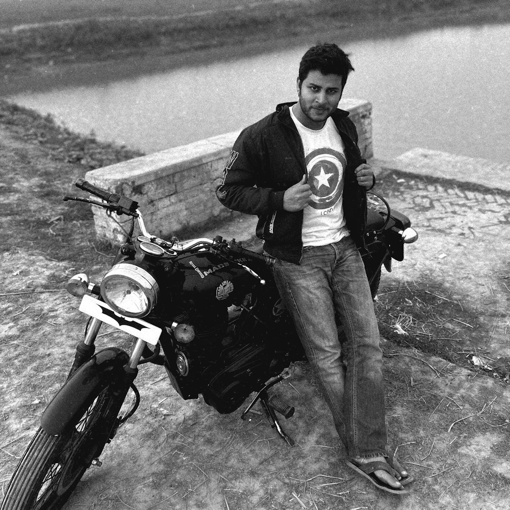 a man sitting on a bench next to a motorcycle