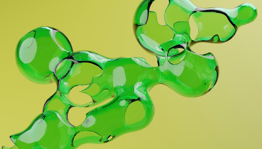 a close up of a green object on a yellow background