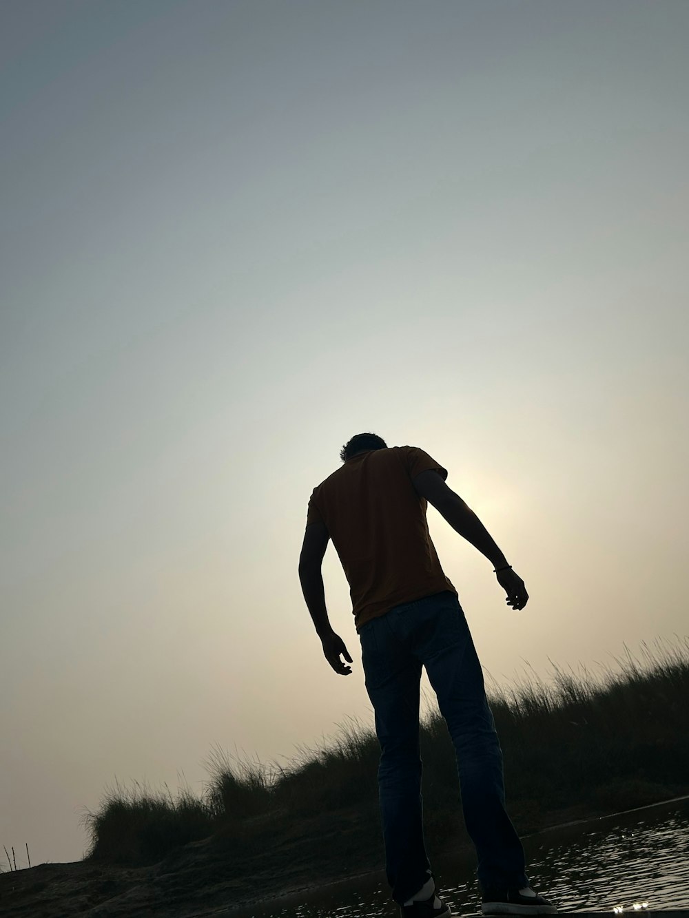 a man riding a skateboard on top of a body of water