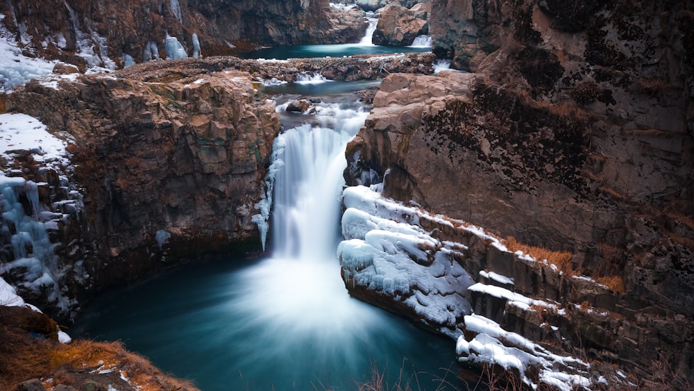 a frozen waterfall in the middle of a canyon
