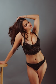 a woman in a black lingerie posing for a picture