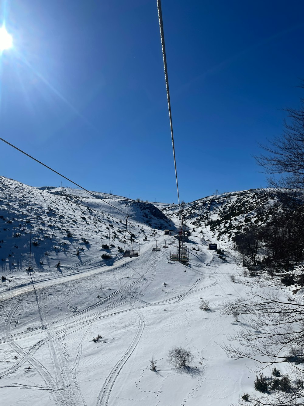 a ski lift going up a snowy hill