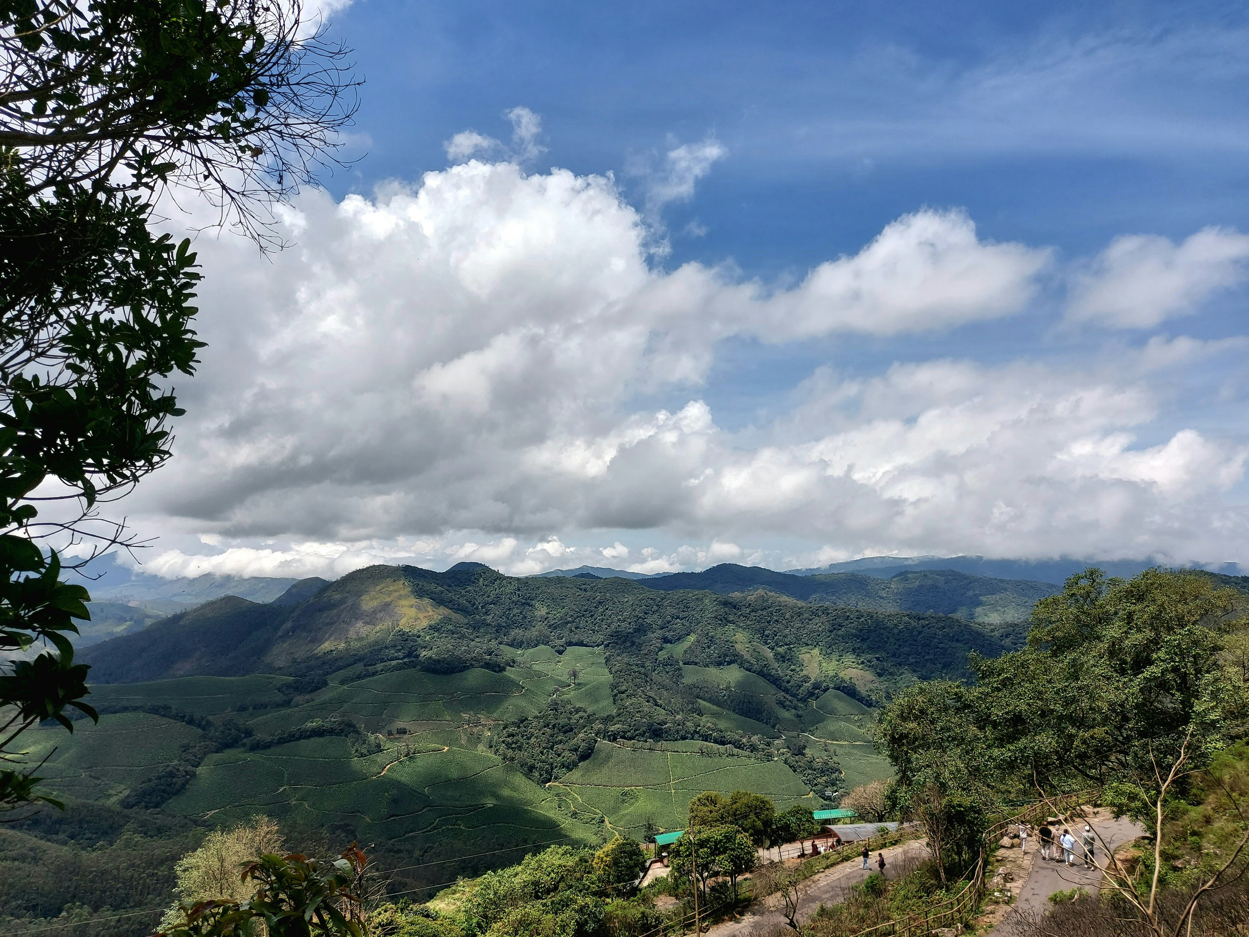 a scenic view of a mountain range with clouds in the sky, 