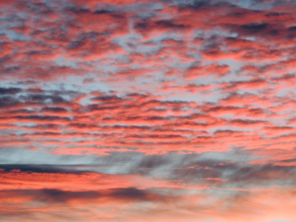 a red and blue sky with some clouds