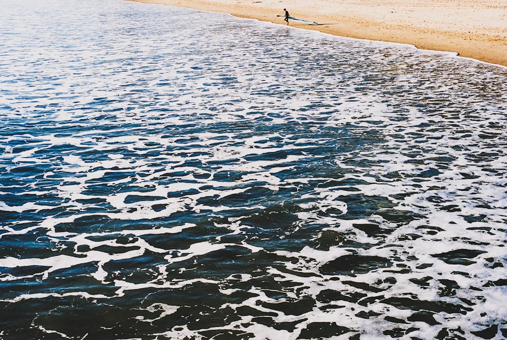 a person standing on a surfboard in the water