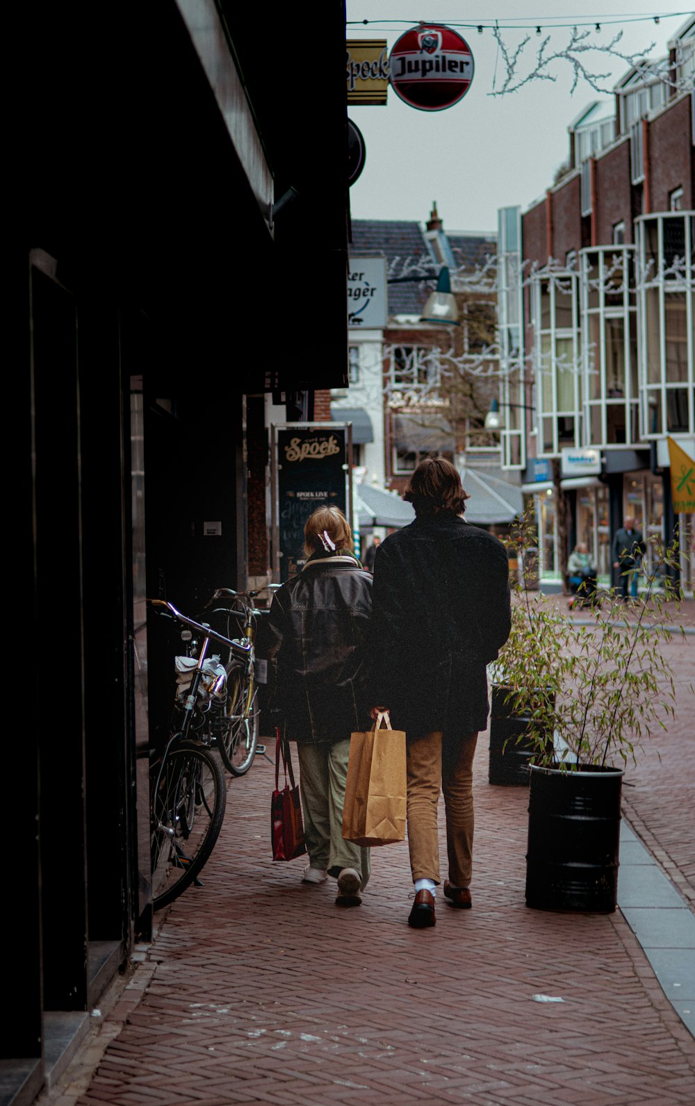 a couple of people walking down a street