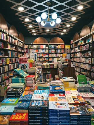 a room filled with lots of books in a library