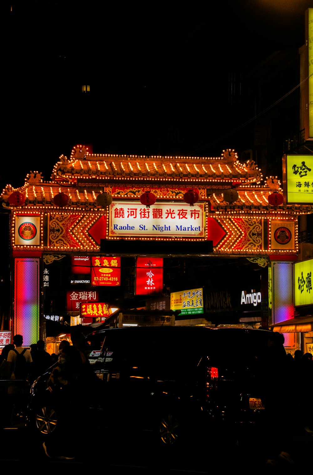 a city street filled with lots of neon signs