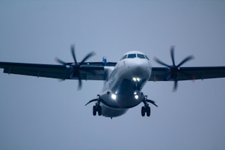 a large white airplane flying through a blue sky