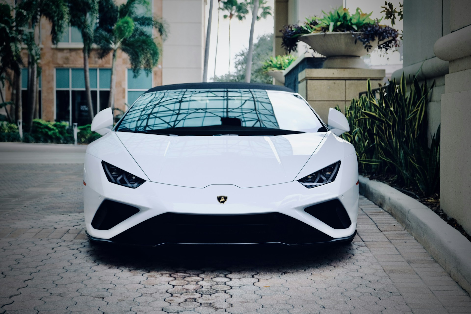 a white sports car parked in front of a building
