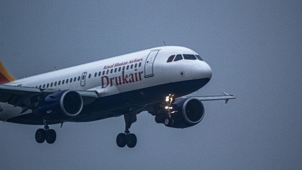 a large jetliner flying through a cloudy sky