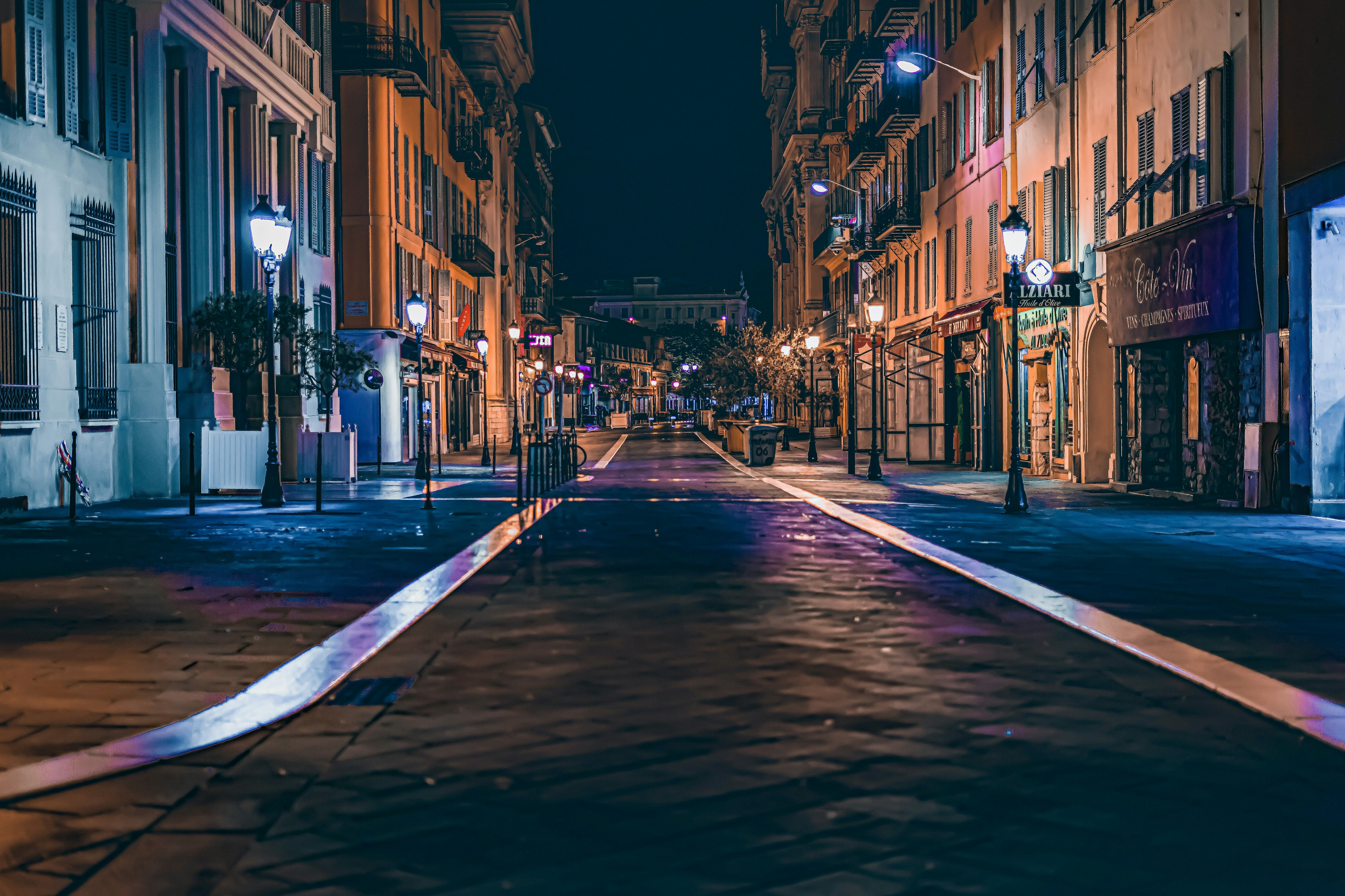 a city street at night with buildings and street lights