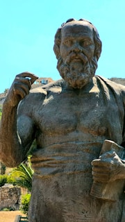 a statue of a man holding a book