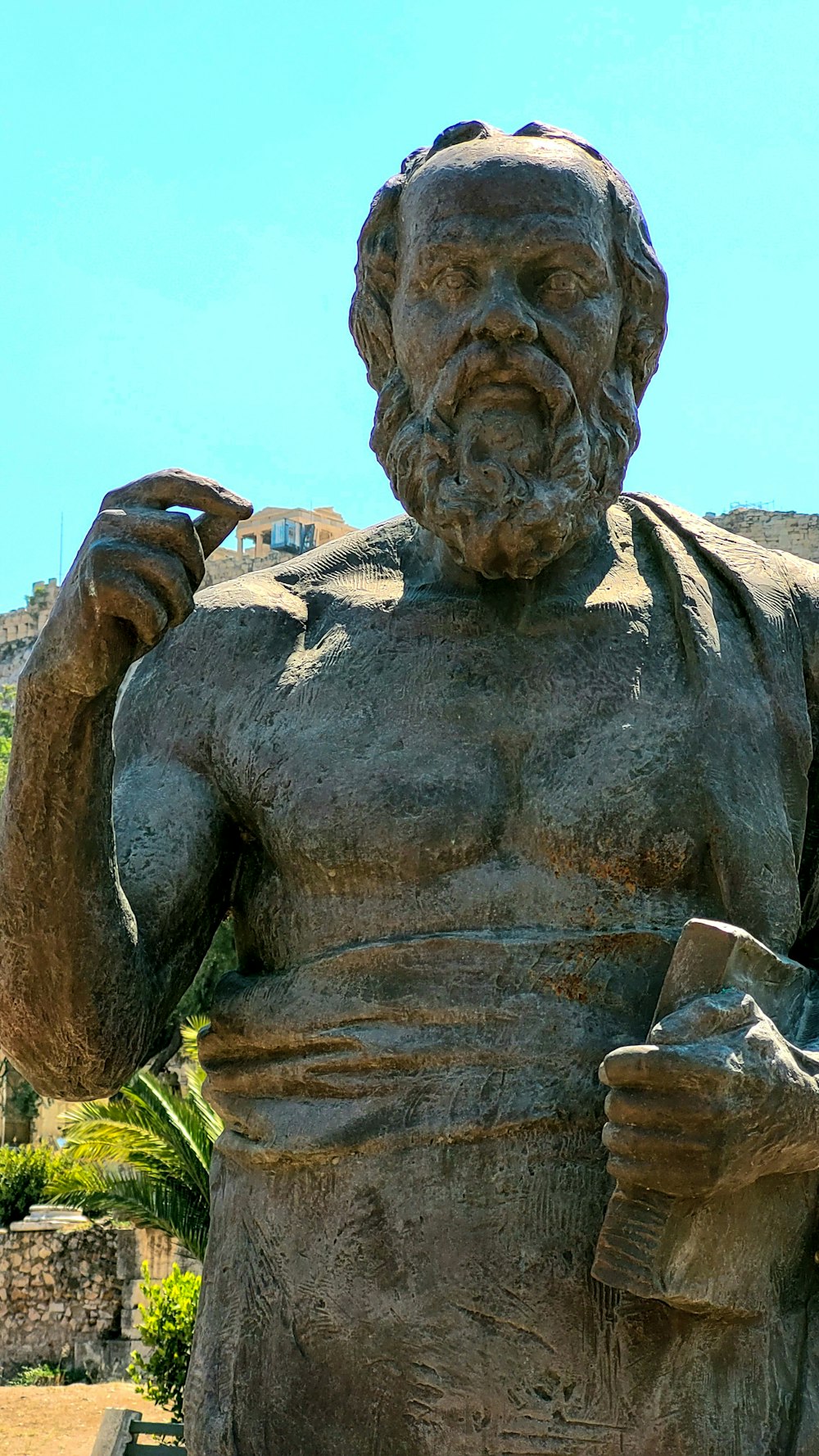 a statue of a man holding a book