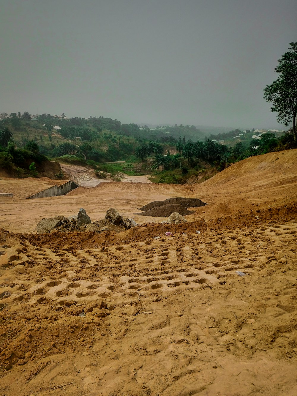 a dirt field with rocks and dirt on the ground