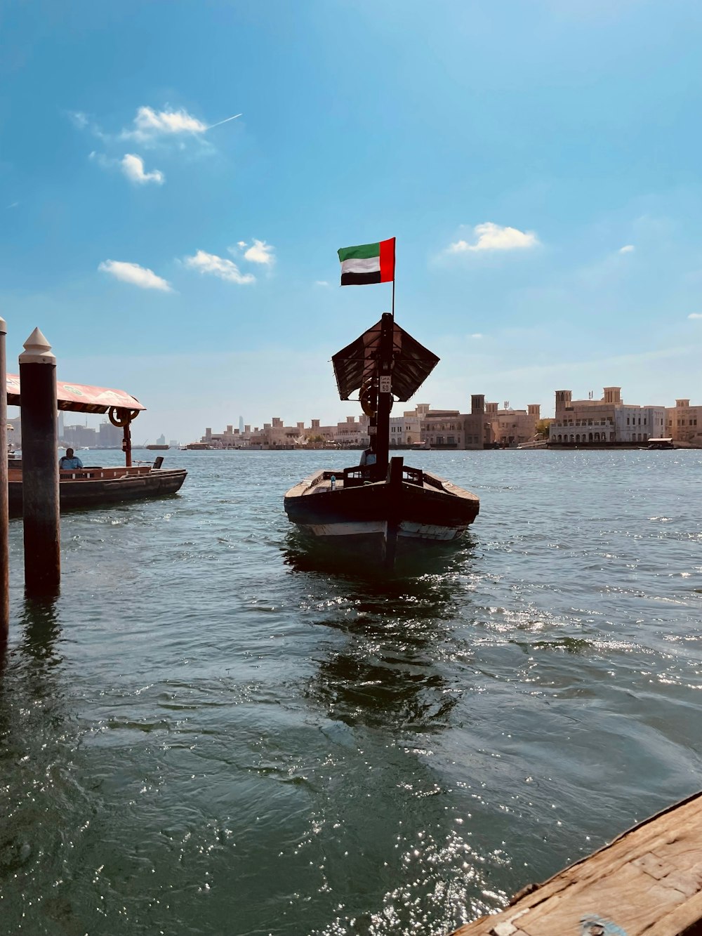 a boat with a flag is in the water