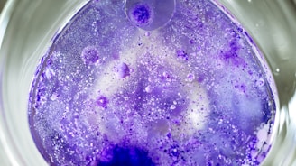 a purple substance is in a glass bowl