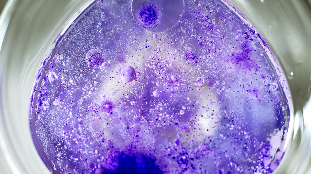 a purple substance is in a glass bowl