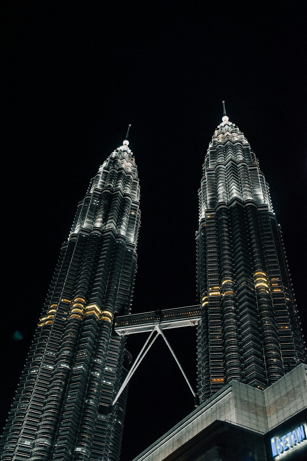 a couple of very tall buildings in the dark