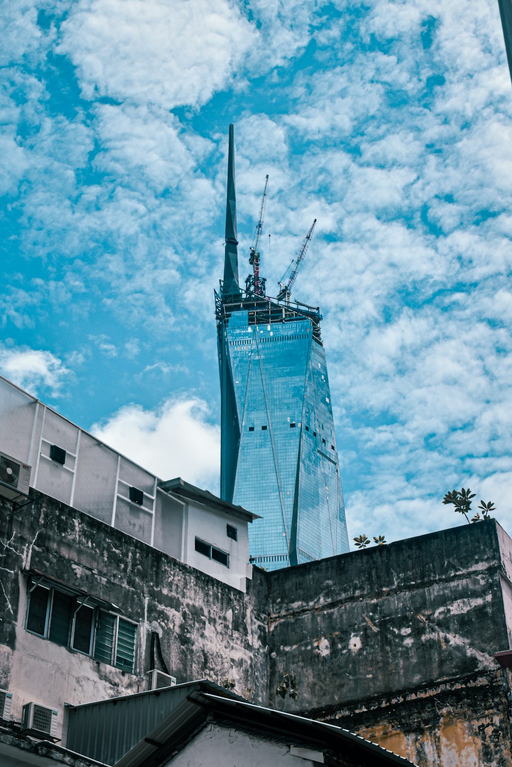 a tall building under a cloudy blue sky