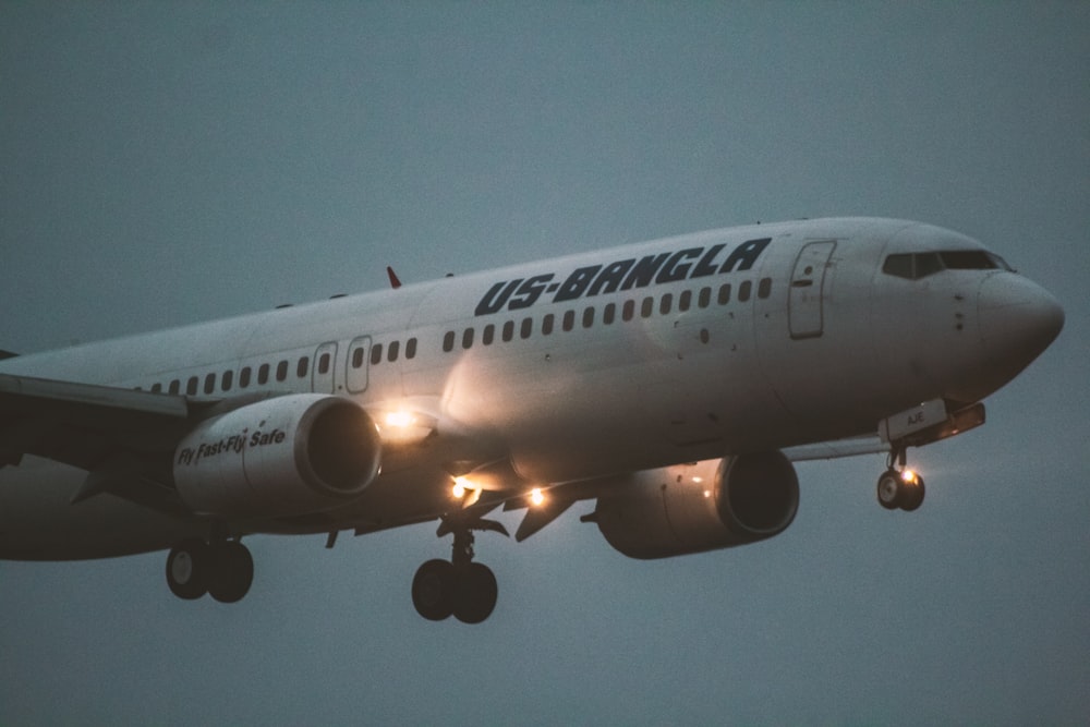 a large jetliner flying through a cloudy sky