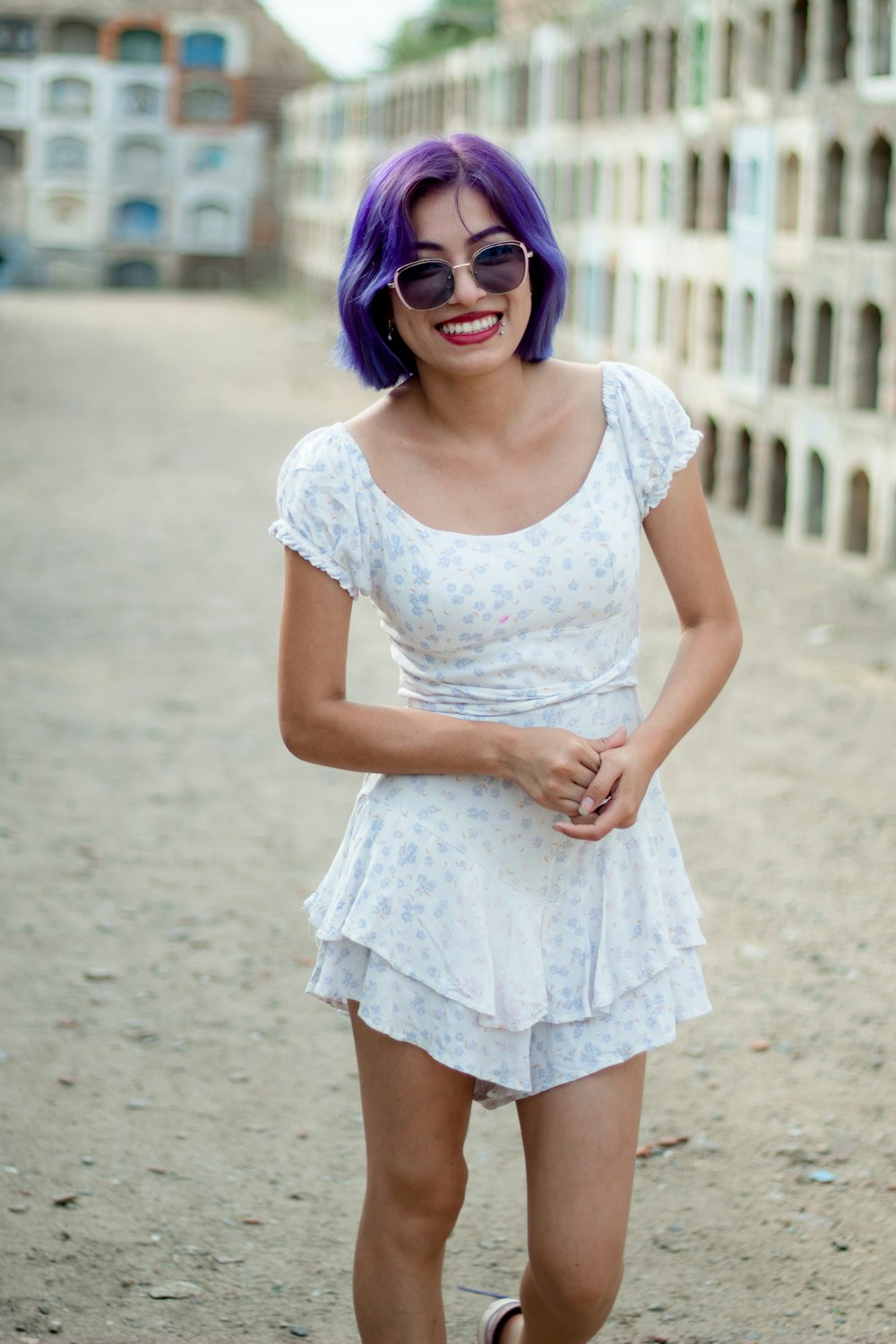 a woman with purple hair wearing a white dress