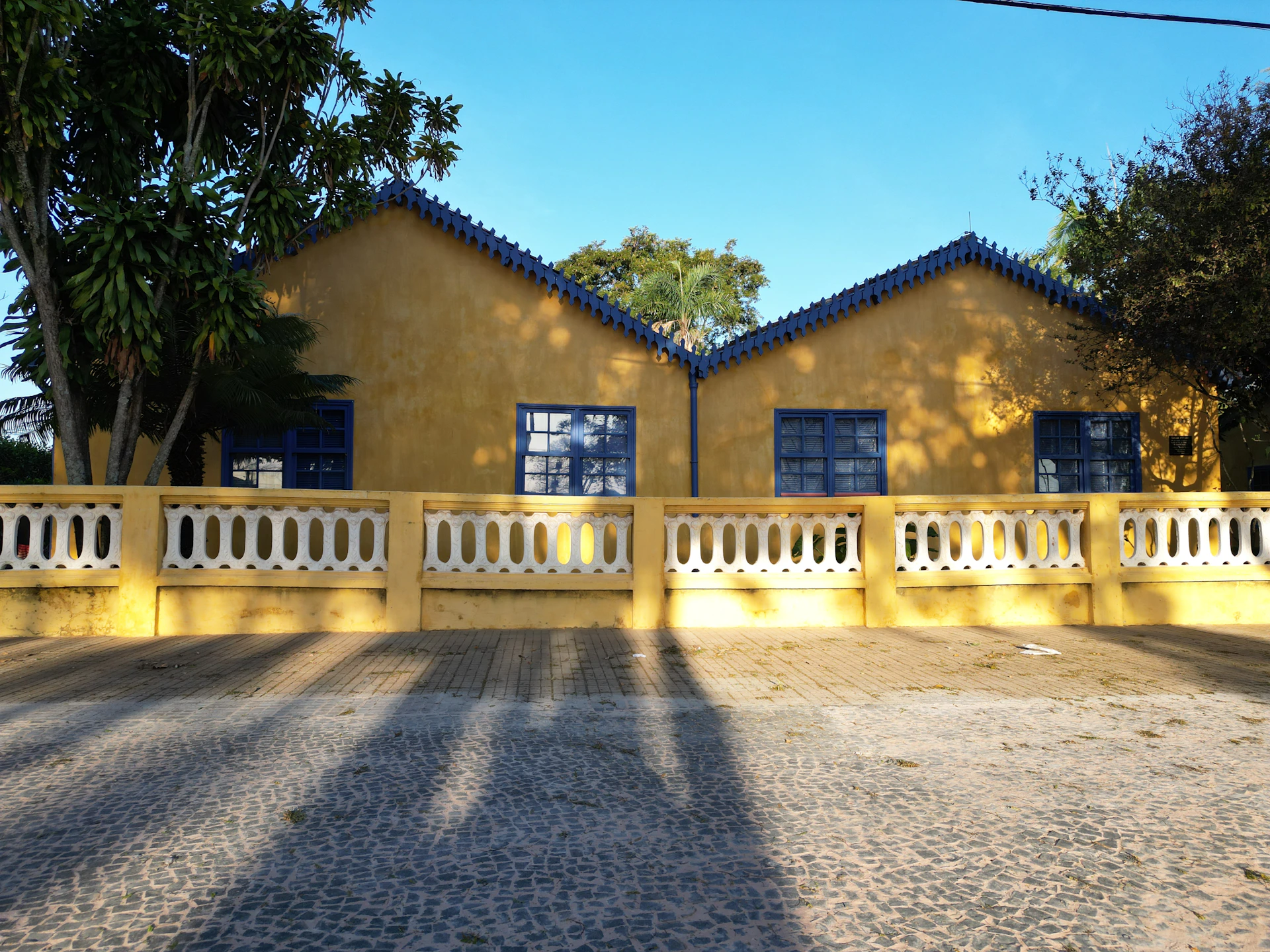 the shadow of a person standing in front of a house