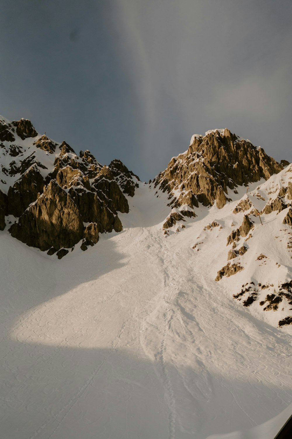 a man riding skis down a snow covered slope