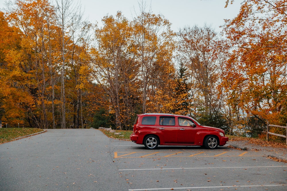 a small red car parked in a parking lot