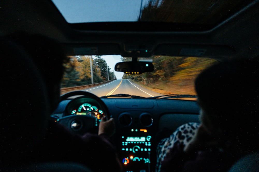 a person driving a car on a road at night