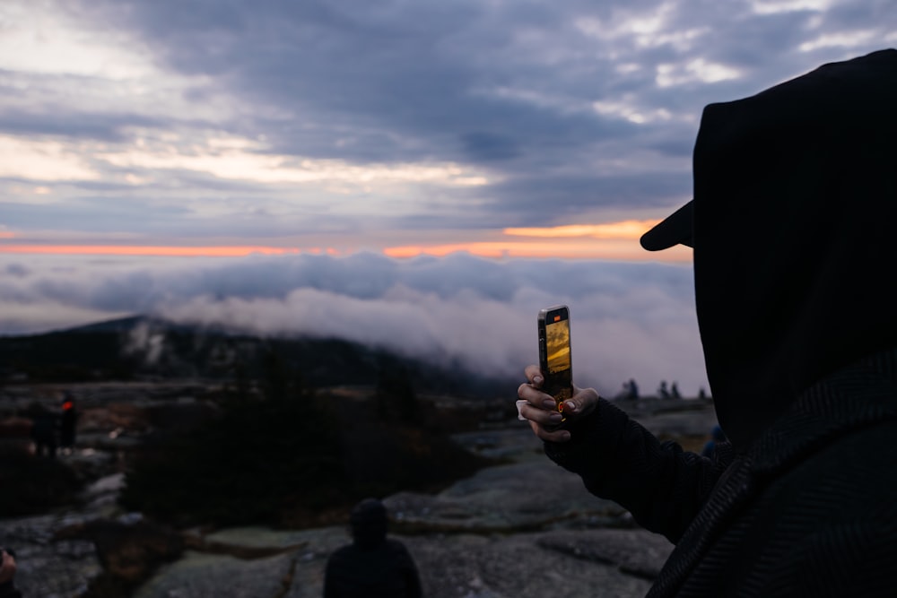 a person taking a picture with a cell phone