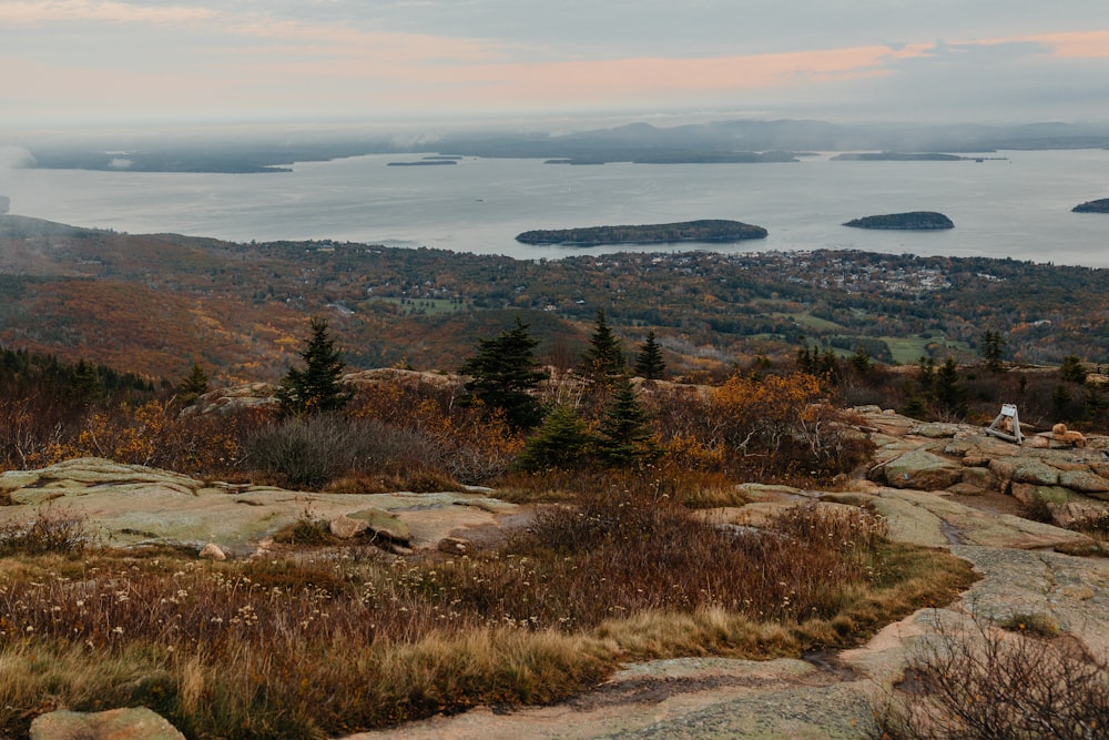 a scenic view of a lake and mountains in the distance