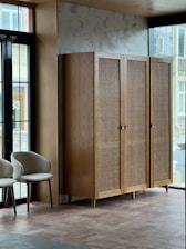 a room with two chairs and a cabinet