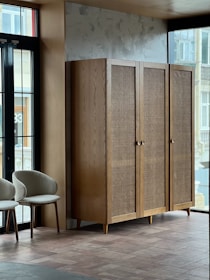 a room with two chairs and a cabinet