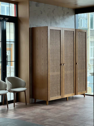 a room with two chairs and a cabinet