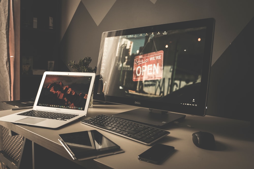 a laptop computer sitting on top of a desk