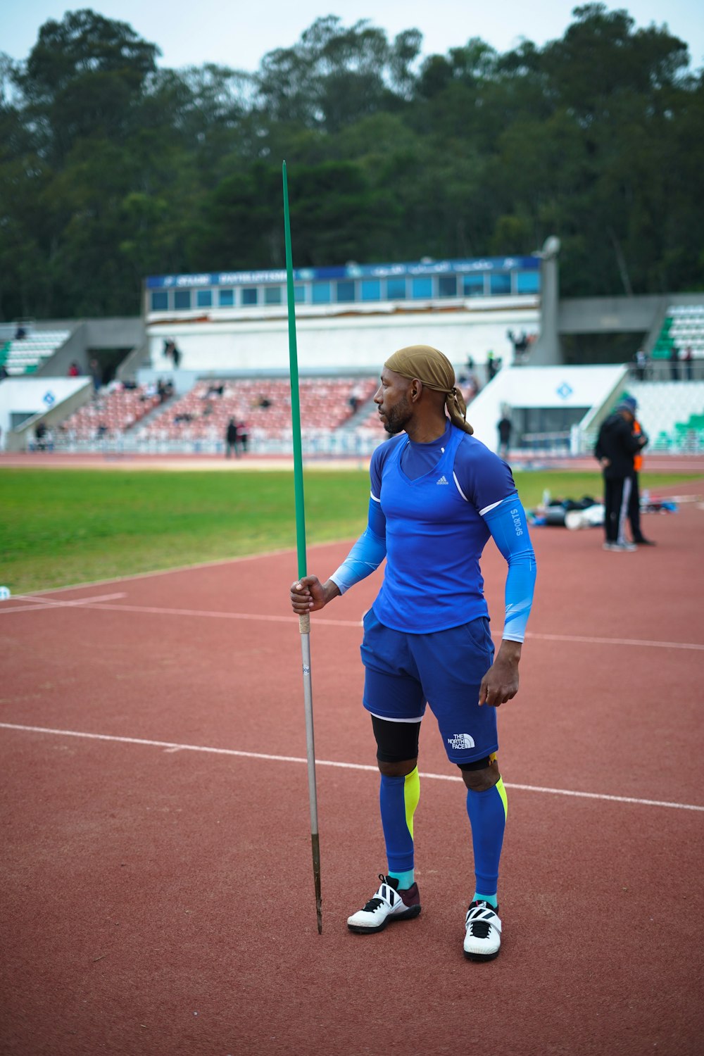 a woman holding a pole on a tennis court